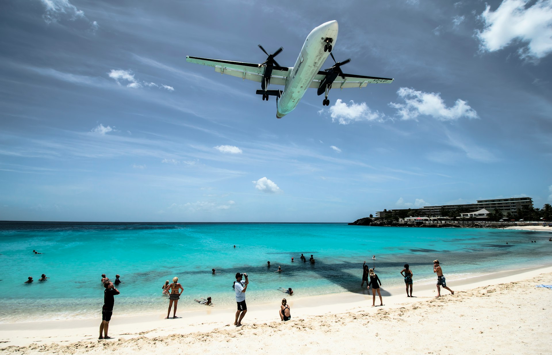 plane flying over seashore during daytime